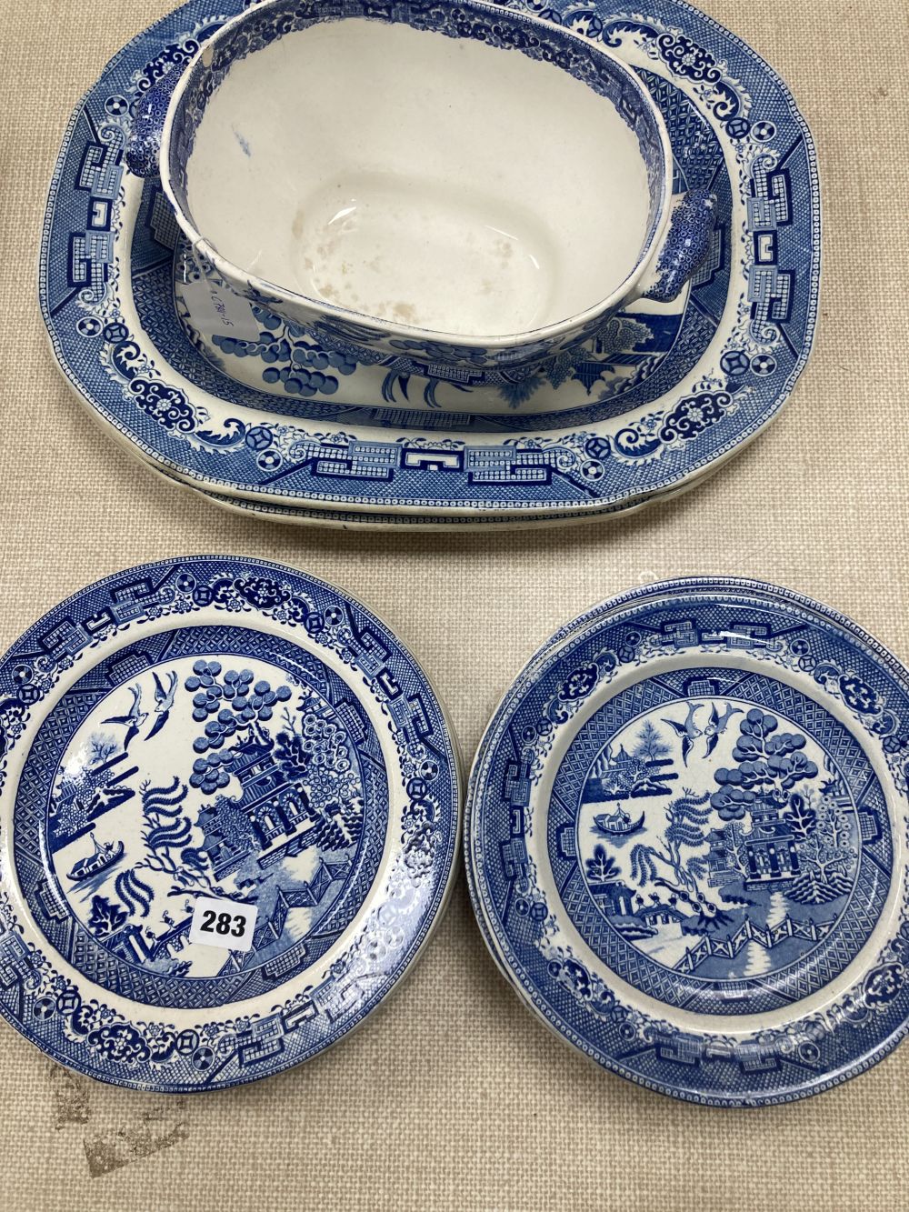 A collection of blue and white Willow pattern plates including meat platters, width 44cm and a tureen